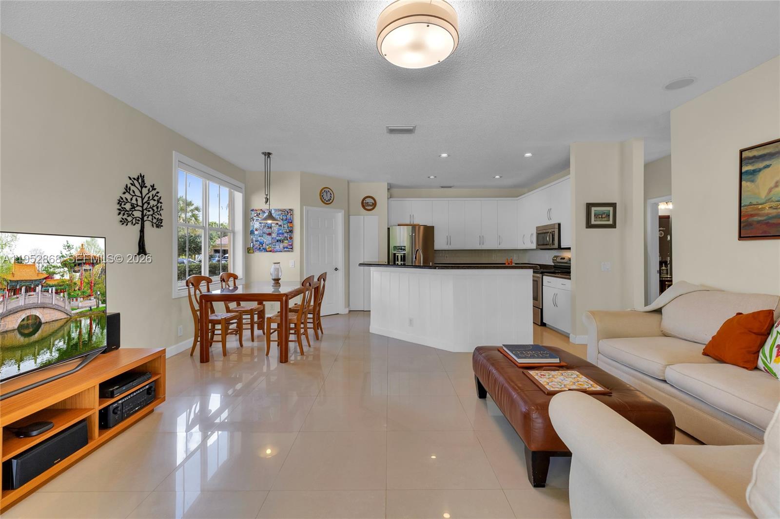 4441 Stone Ridge Way Weston, FL 33331 - Photo 23 of 87 a living room with furniture and a flat screen tv