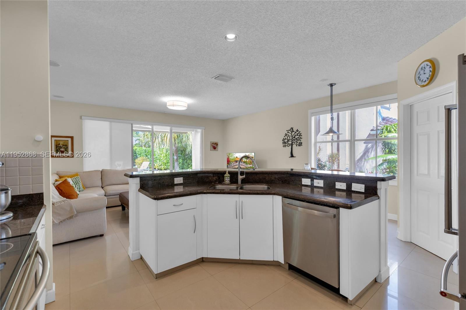 4441 Stone Ridge Way Weston, FL 33331 - Photo 26 of 87 a kitchen with granite countertop a sink and white cabinets