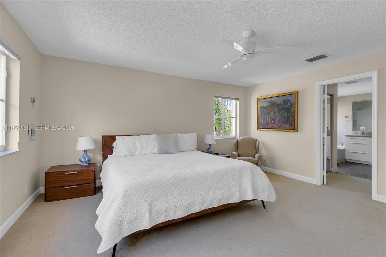 4441 Stone Ridge Way Weston, FL 33331 - Photo 41 of 87 a bedroom with a bed and a chandelier