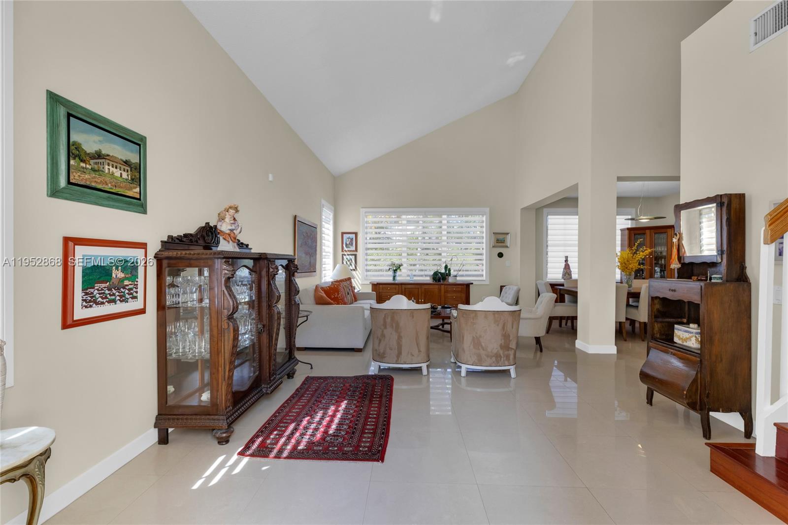 4441 Stone Ridge Way Weston, FL 33331 - Photo 57 of 87 a living room with furniture a window and a flat screen tv