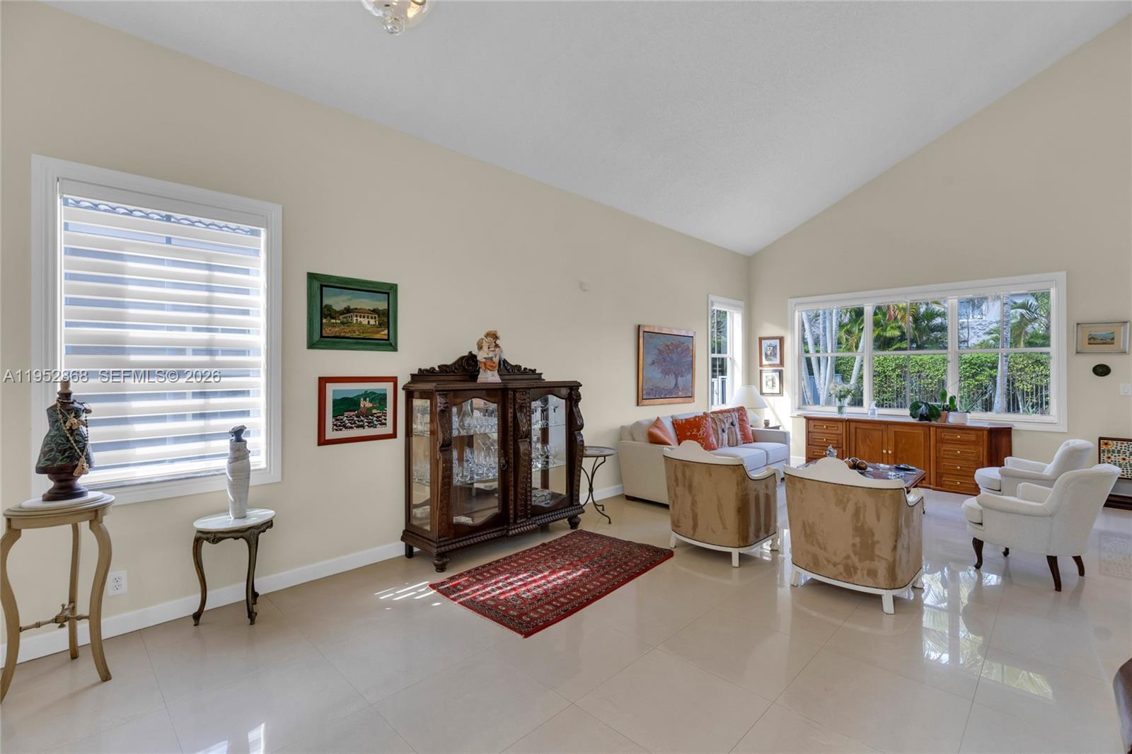 4441 Stone Ridge Way Weston, FL 33331 - Photo 8 of 87 a living room with furniture a window and a flat screen tv