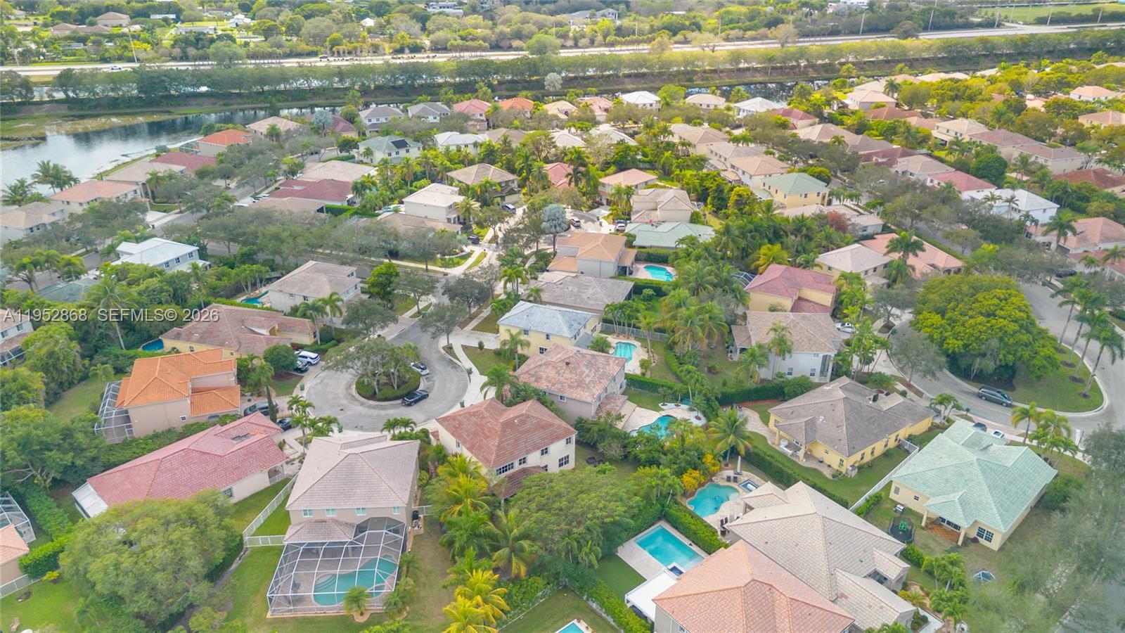 4441 Stone Ridge Way Weston, FL 33331 - Photo 82 of 87 an aerial view of residential houses with outdoor space and lake view
