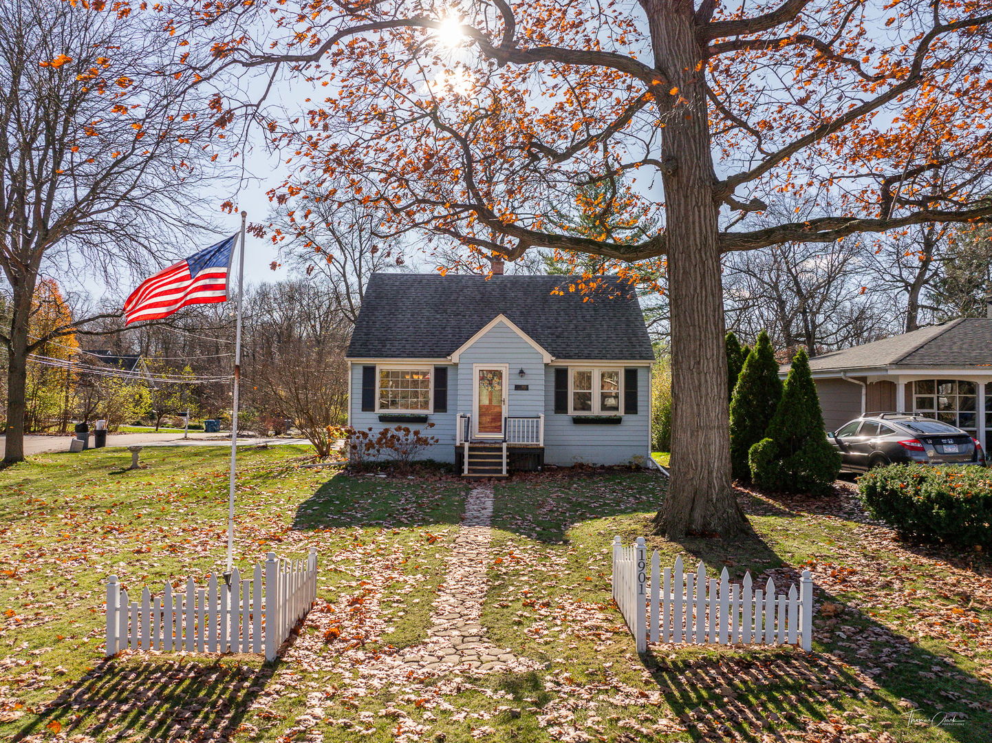 1901 Curtiss Street Downers Grove, IL 60515 - Photo 1 of 45 a front view of a house with a yard table and chairs