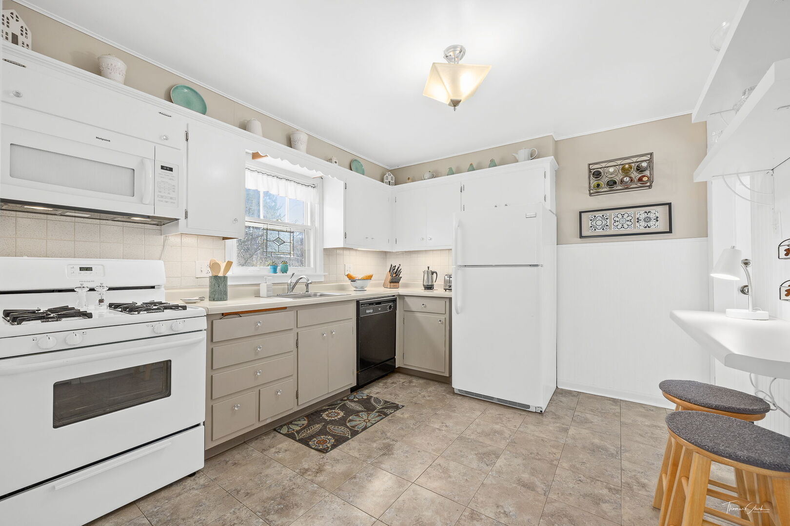 1901 Curtiss Street Downers Grove, IL 60515 - Photo 15 of 45 a kitchen with a white stove refrigerator and white cabinets