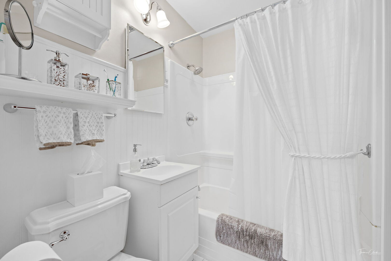 1901 Curtiss Street Downers Grove, IL 60515 - Photo 22 of 45 a bathroom with a sink a toilet and shower curtain