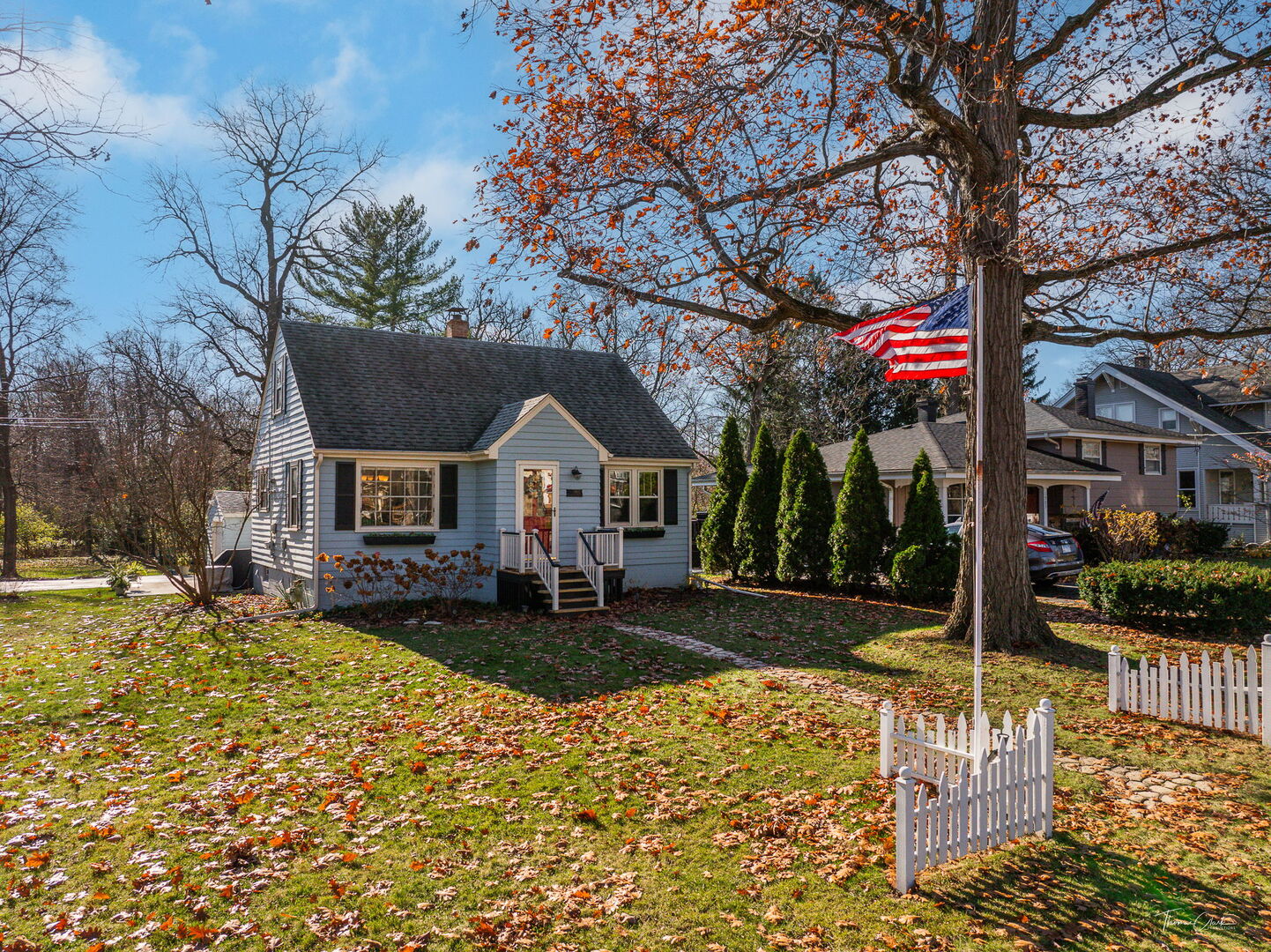 1901 Curtiss Street Downers Grove, IL 60515 - Photo 24 of 45 a front view of a house with a yard covered with snow