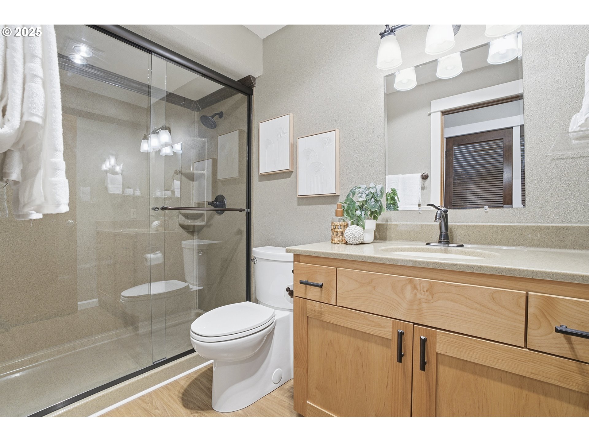10955 Southwest Meadowbrook Drive, Unit 16 Portland, OR 97224 - Photo 16 of 26 a bathroom with a sink a toilet and shower