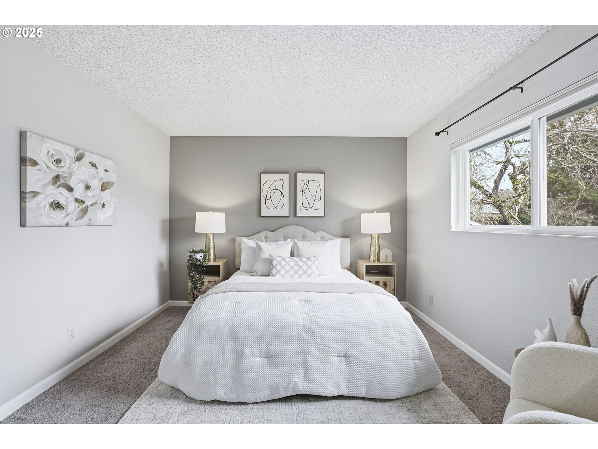 10955 Southwest Meadowbrook Drive, Unit 16 Portland, OR 97224 - Photo 18 of 26 a bedroom with a large bed and a painting on the wall