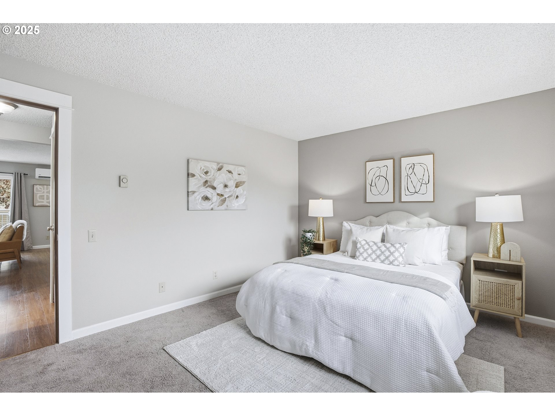 10955 Southwest Meadowbrook Drive, Unit 16 Portland, OR 97224 - Photo 19 of 26 a bedroom with a bed and a painting on the wall