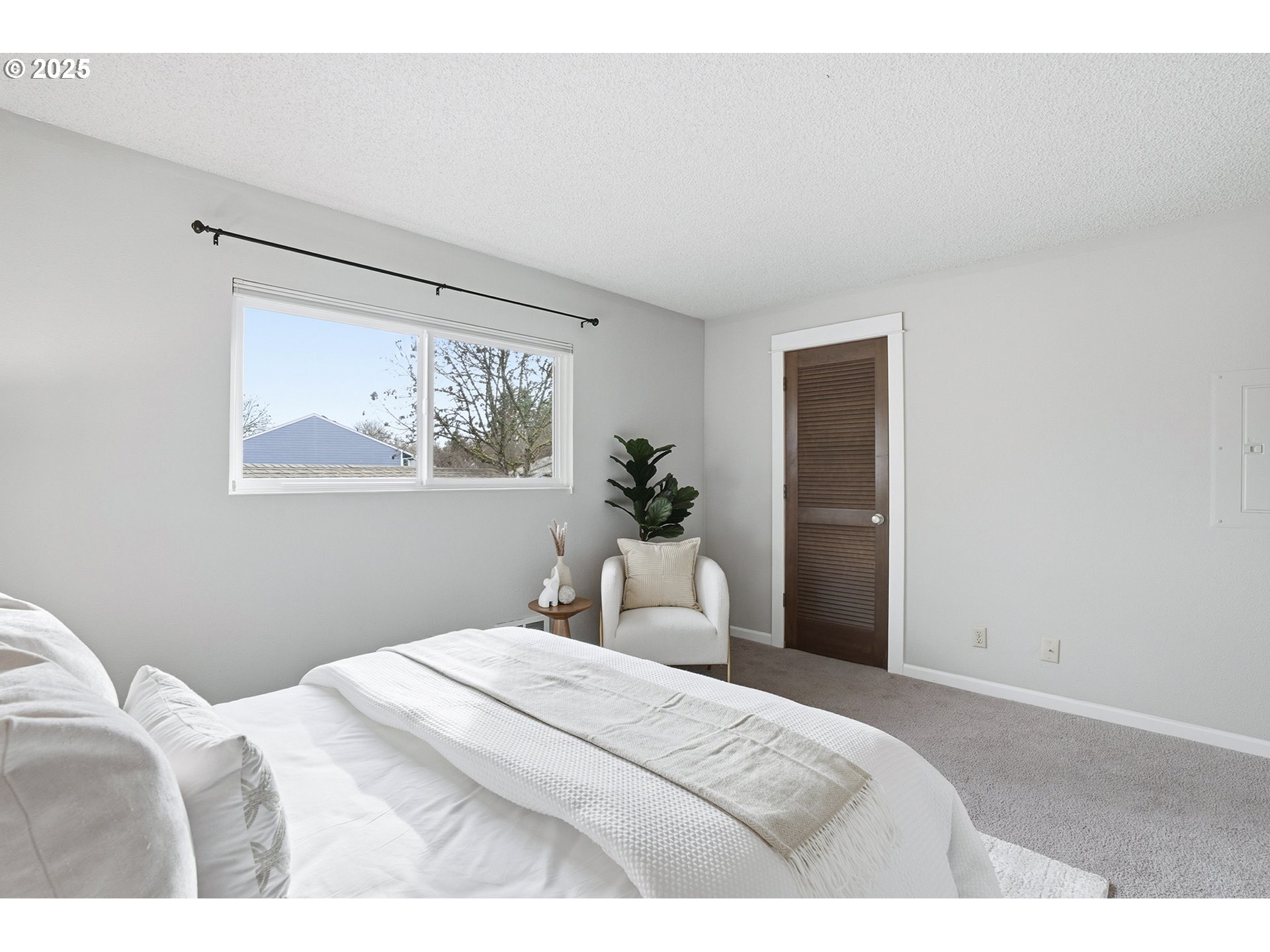 10955 Southwest Meadowbrook Drive, Unit 16 Portland, OR 97224 - Photo 20 of 26 a bedroom with a bed and a painting on the wall