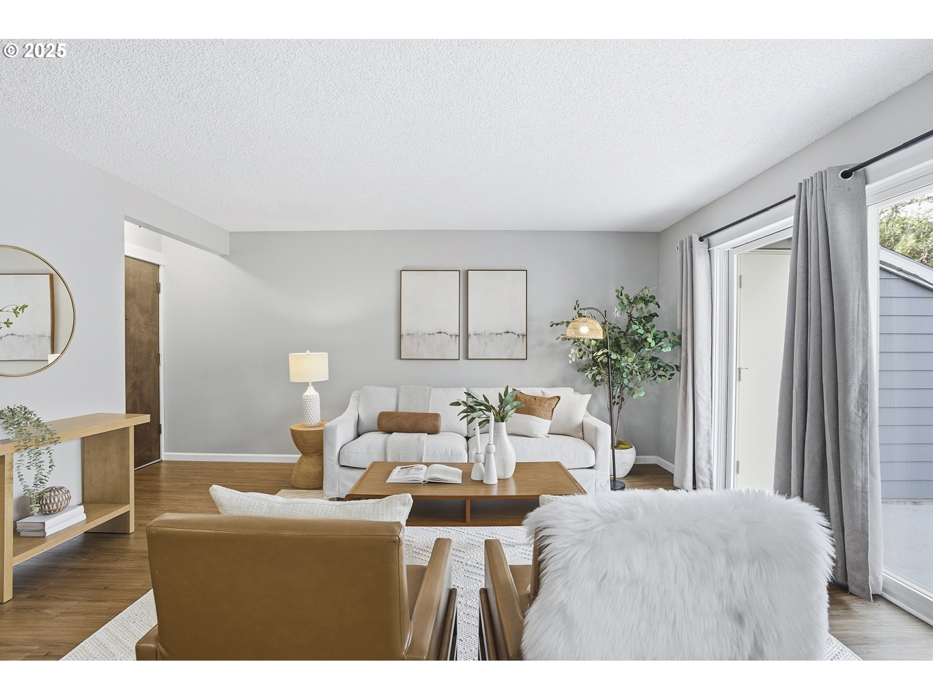 10955 Southwest Meadowbrook Drive, Unit 16 Portland, OR 97224 - Photo 5 of 26 a living room with furniture a window and a mirror