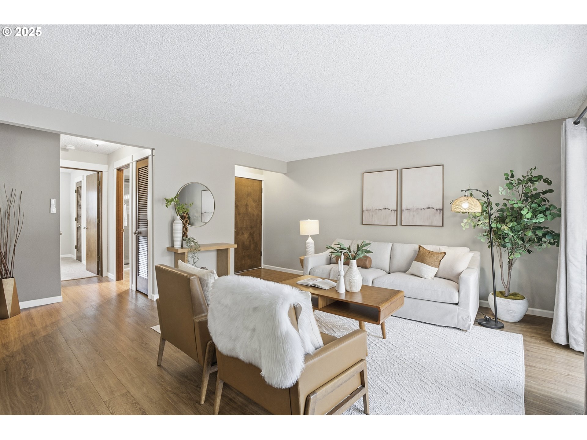 10955 Southwest Meadowbrook Drive, Unit 16 Portland, OR 97224 - Photo 6 of 26 a living room with furniture and a wooden floor