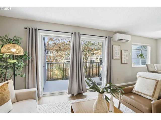 a living room with furniture and a floor to ceiling window