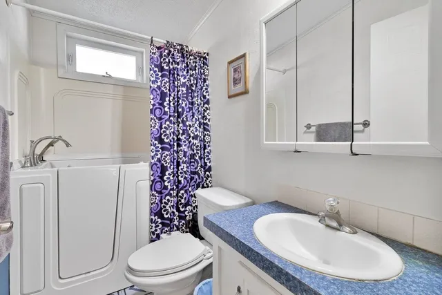 a bedroom with a bed and a lamp on table