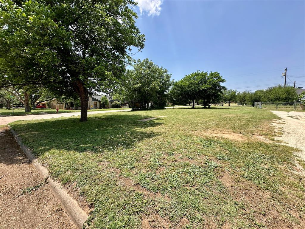 512 Oak Street Merkel, TX 79536 - Photo 4 of 4 a view of a big yard with an trees