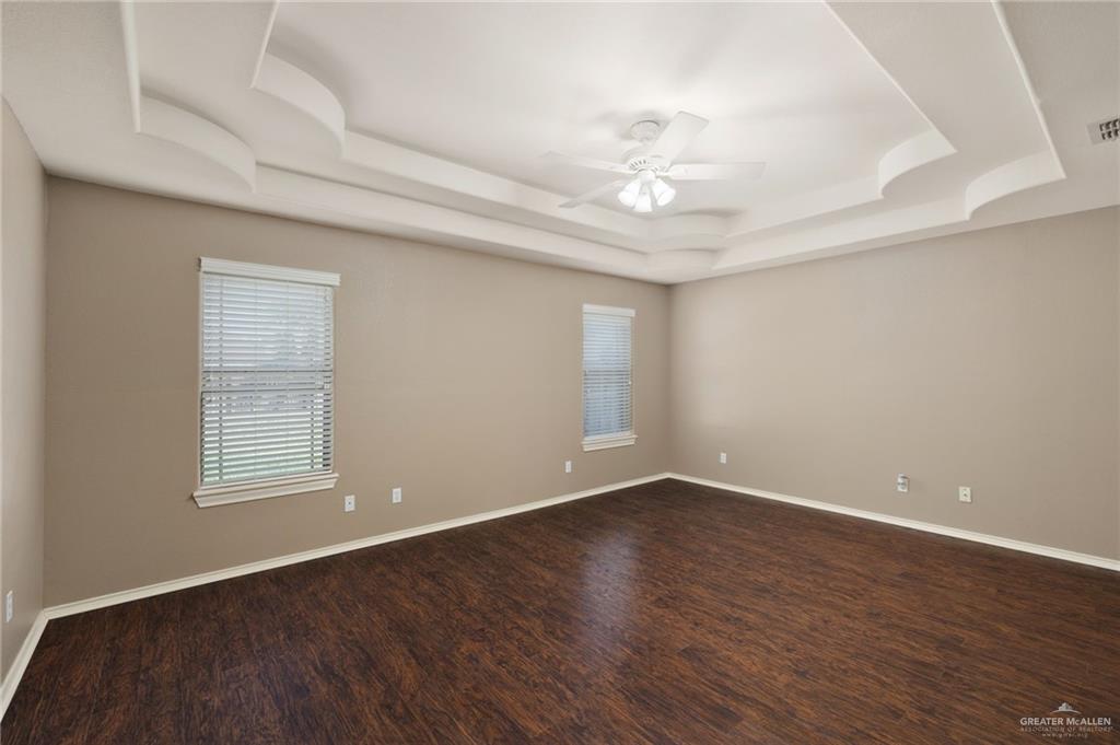 2111 East 25th Street Mission, TX 78574 - Photo 9 of 19 an empty room with wooden floor and windows