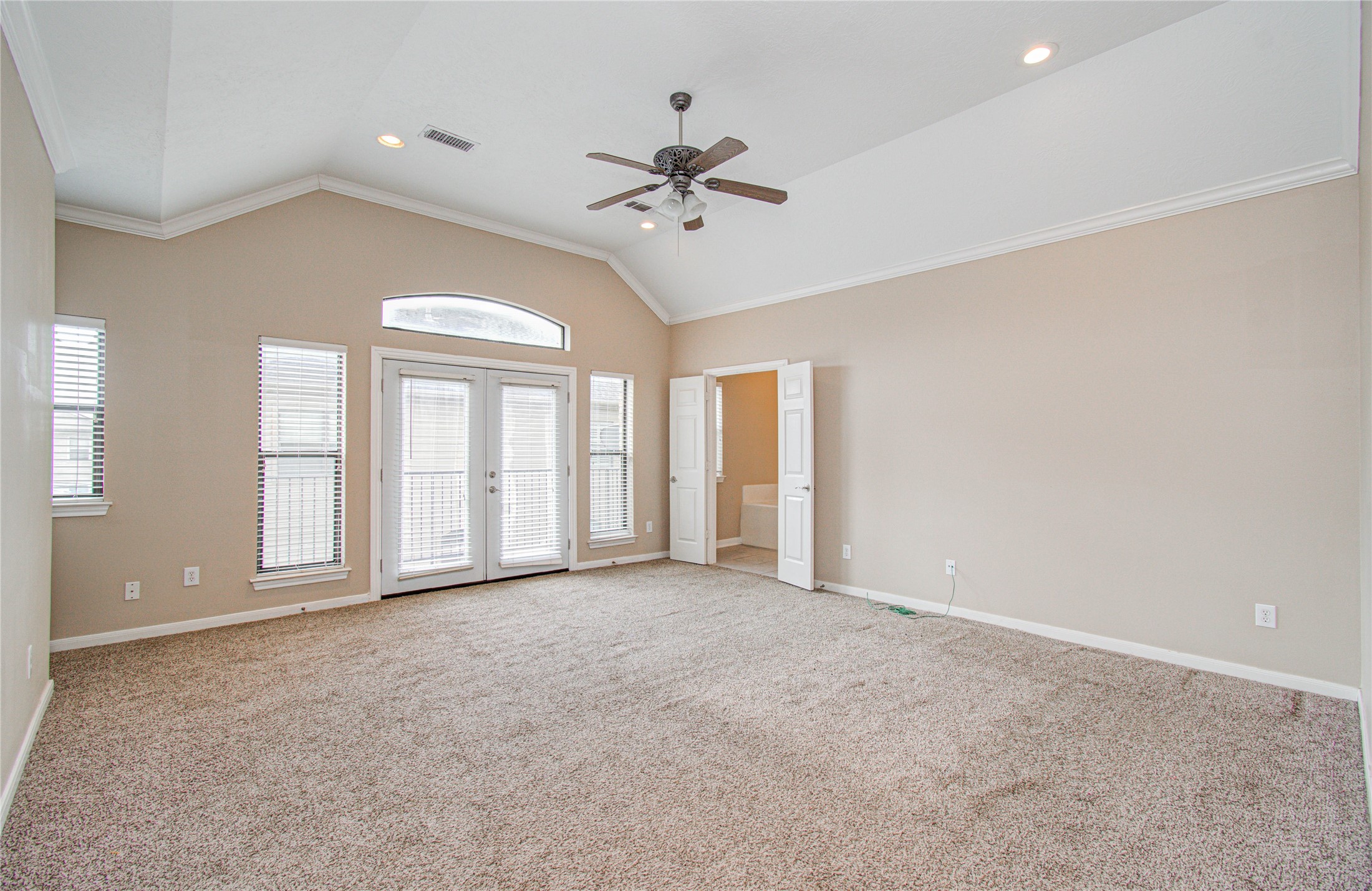 2304 Jackson Street Houston, TX 77004 - Photo 17 of 31 Primary bedroom features high ceiling, large windows and French doors for ample natural light, leading to the balcony.