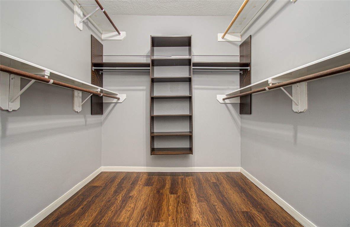 2304 Jackson Street Houston, TX 77004 - Photo 25 of 31 Walk-in closet located off primary bathroom features hardwood floors, plenty of hanging space, and open shelving.