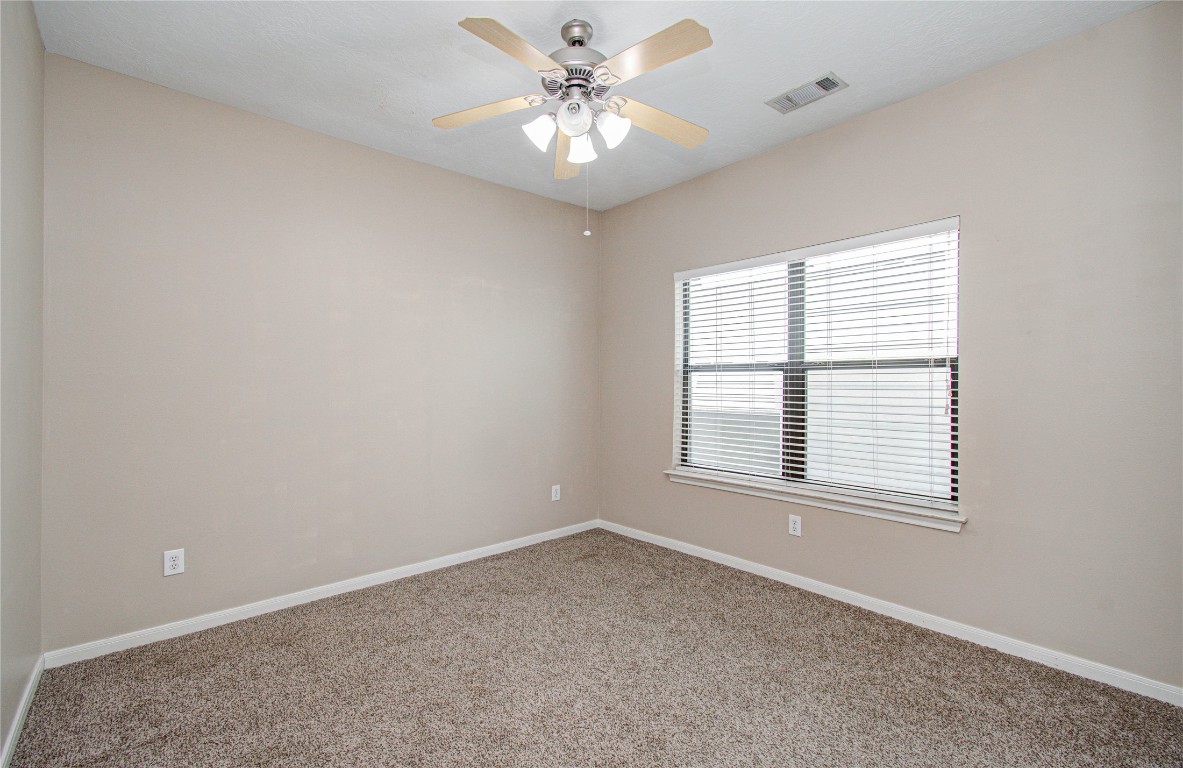 2304 Jackson Street Houston, TX 77004 - Photo 26 of 31 Secondary bedroom features large window offering natural light, creating a bright and inviting space.