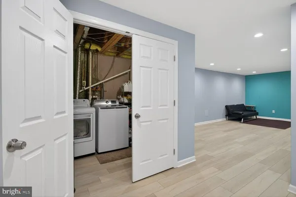 a view of a storage & utility room with closet dryer