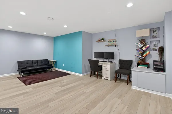 a workspace with wooden floor and furniture