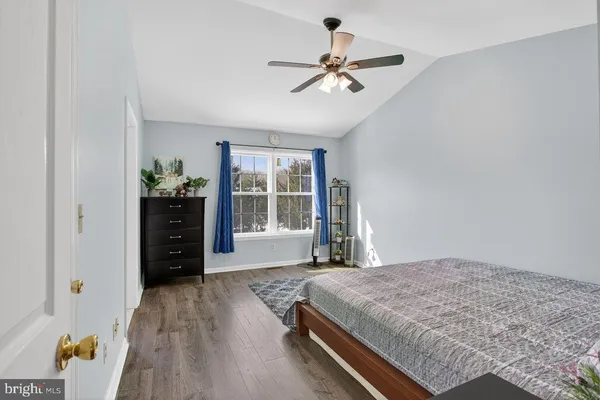 a spacious bedroom with a bed and a chandelier