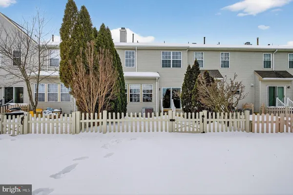 a view of a house with wooden fence