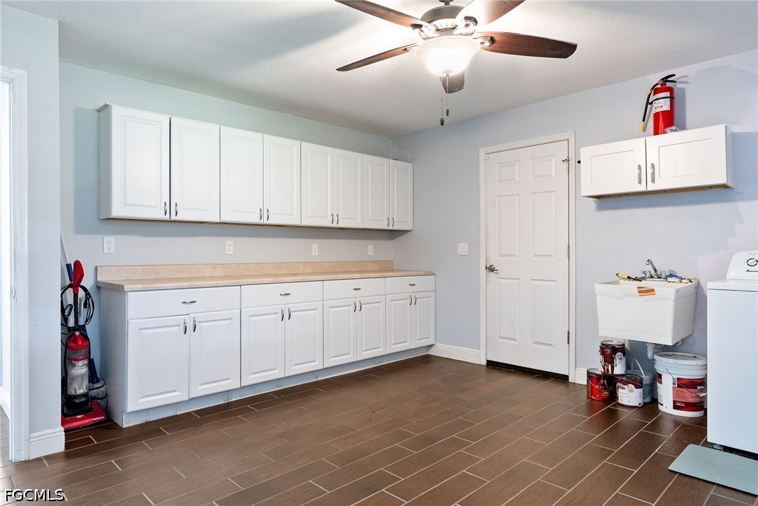 17290 Rewis Road Alva, FL 33920 - Photo 22 of 50 a kitchen with cabinets and window