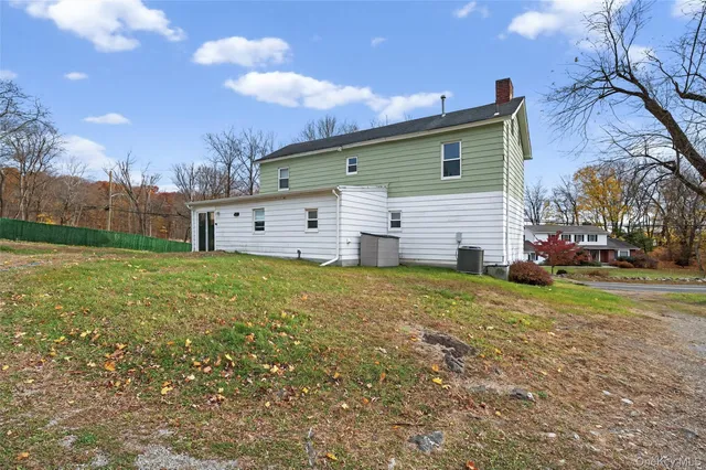 a front view of house with yard and trees