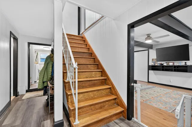 a view of entryway and hall with wooden floor
