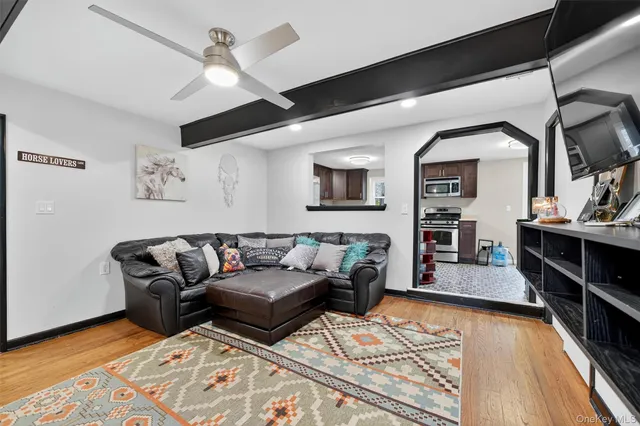 a living room with furniture and a wooden floor