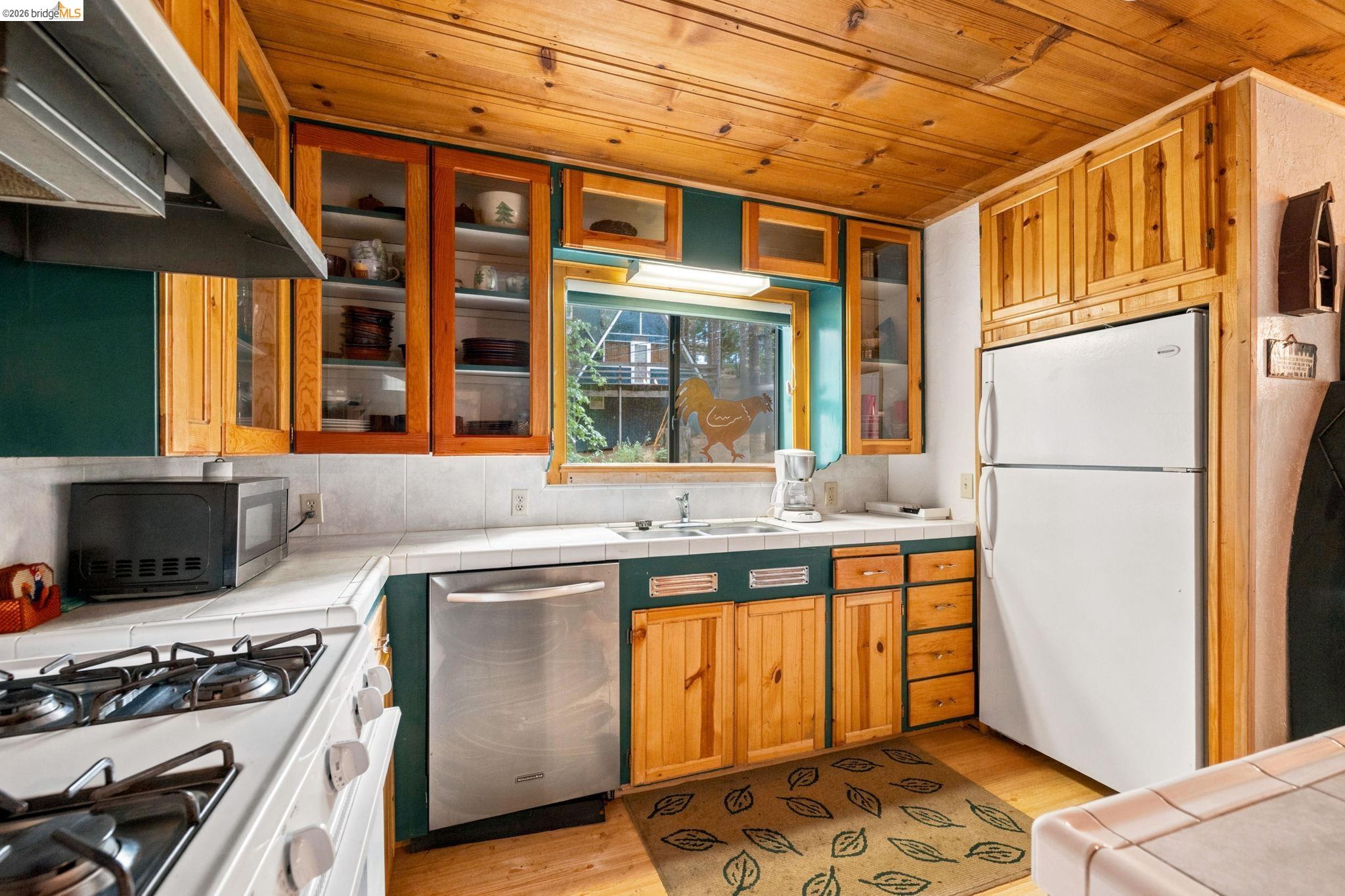 25822 Long Barn Sugar Pine Road Long Barn, CA 95335 - Photo 11 of 28 a kitchen with stainless steel appliances granite countertop a stove and a refrigerator