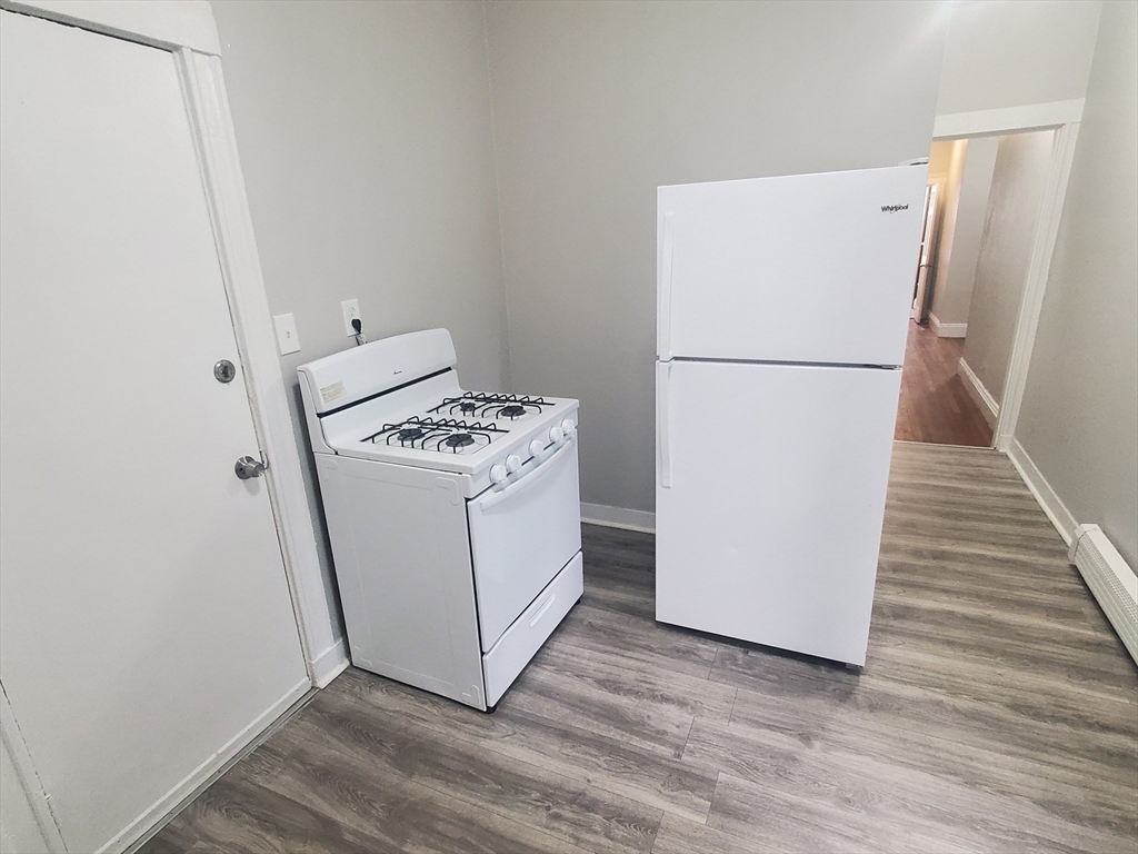 76 Walnut Park, Unit 1 Boston, MA 02119 - Photo 3 of 12 a utility room with washer and dryer