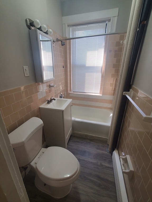 76 Walnut Park, Unit 1 Boston, MA 02119 - Photo 9 of 12 a bathroom with a sink toilet and shower