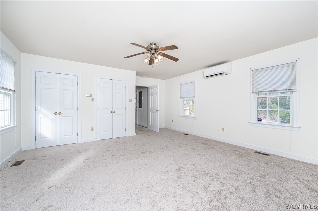 13530 Spring Run Road Midlothian, VA 23112 - Photo 20 of 41 an empty room with chandelier fan and windows