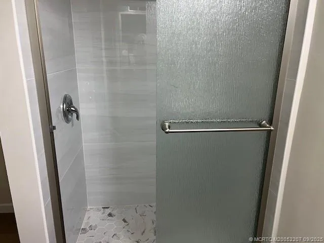 a bathroom with a glass shower door