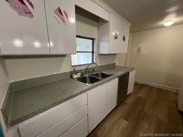 a kitchen that has a sink and a stove