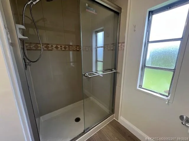 a bathroom with a glass shower door