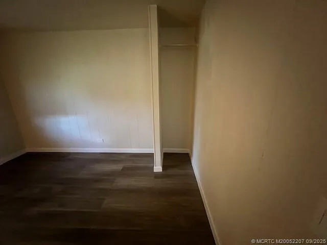 a view of an empty room and wooden floor