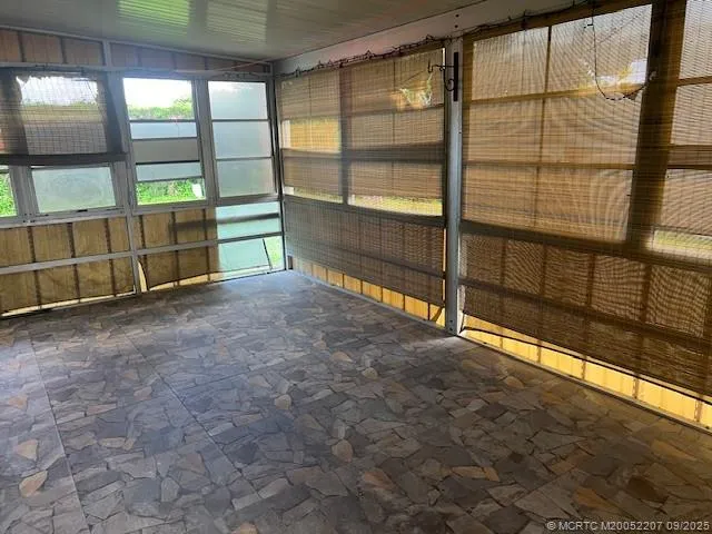 a view of an empty room with windows