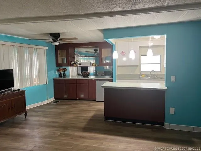 a view of kitchen with cabinets and wooden floor