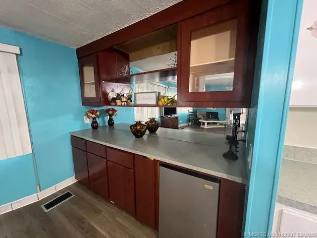 a kitchen with stainless steel appliances a sink cabinets and a window