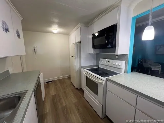 a kitchen with a stove and a microwave