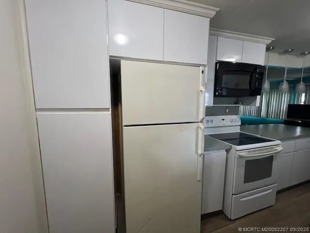 a kitchen with stainless steel appliances granite countertop a refrigerator and a microwave