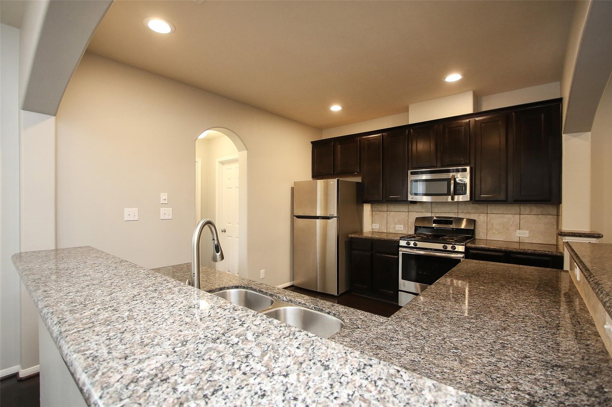 8517 Sunset Loch Drive Spring, TX 77379 - Photo 9 of 22 a kitchen with refrigerator and microwave