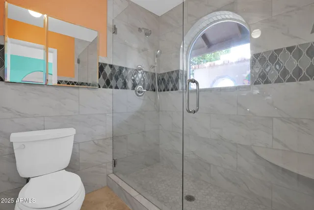 a view of porch with a table and chairs under an umbrella