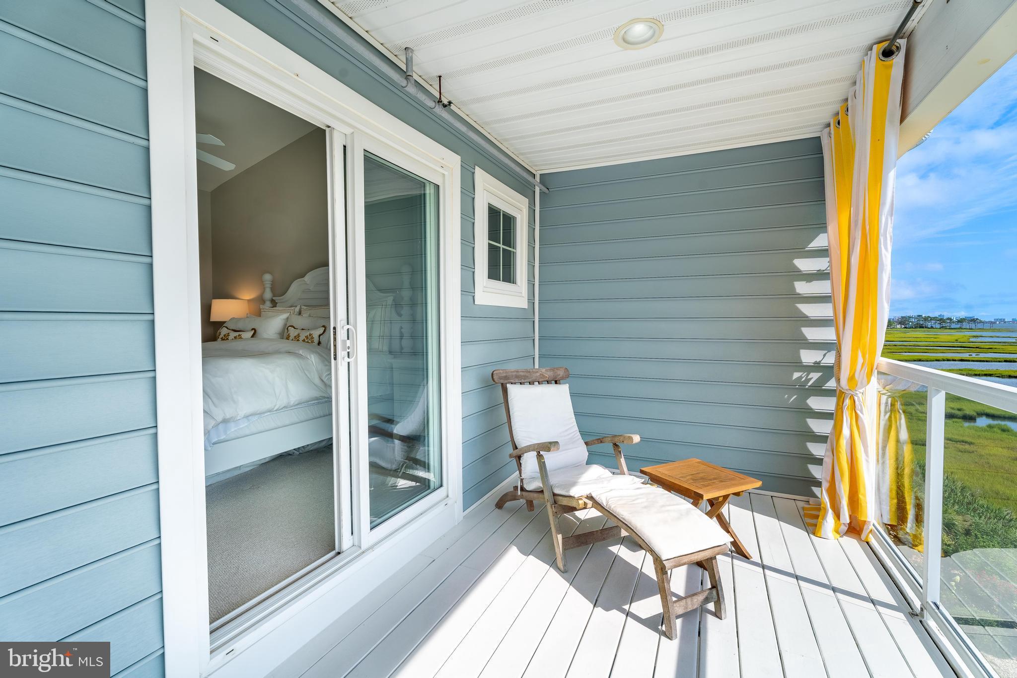 37304 Lighthouse Road, Unit 10 Selbyville, DE 19975 - Photo 11 of 40 a view of a balcony with chairs and wooden floor