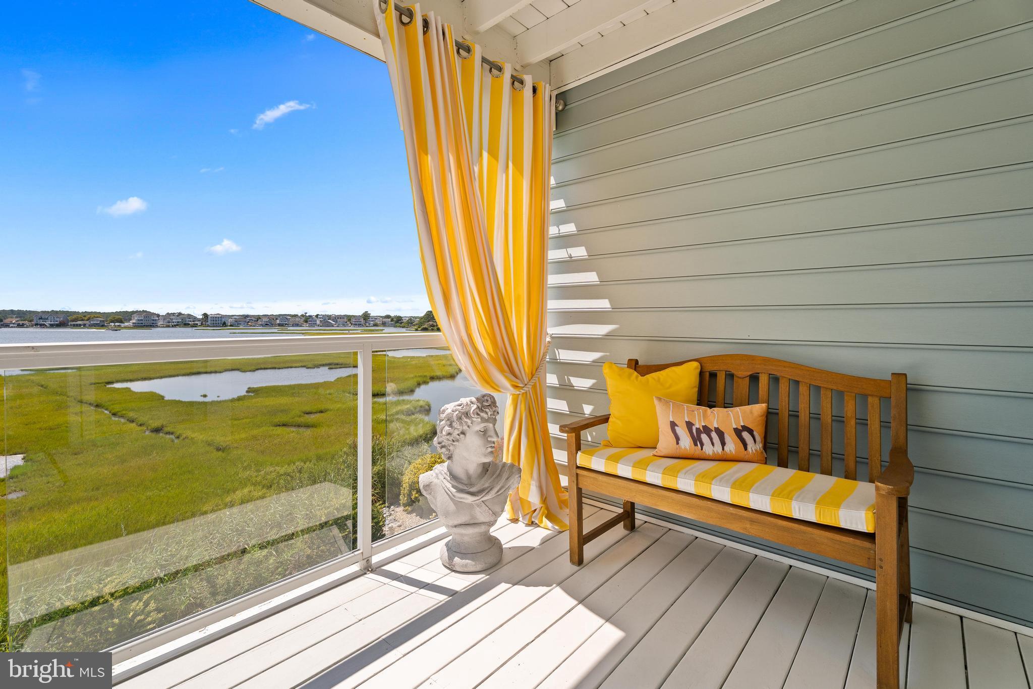 37304 Lighthouse Road, Unit 10 Selbyville, DE 19975 - Photo 13 of 40 a blue bench sitting next to a window