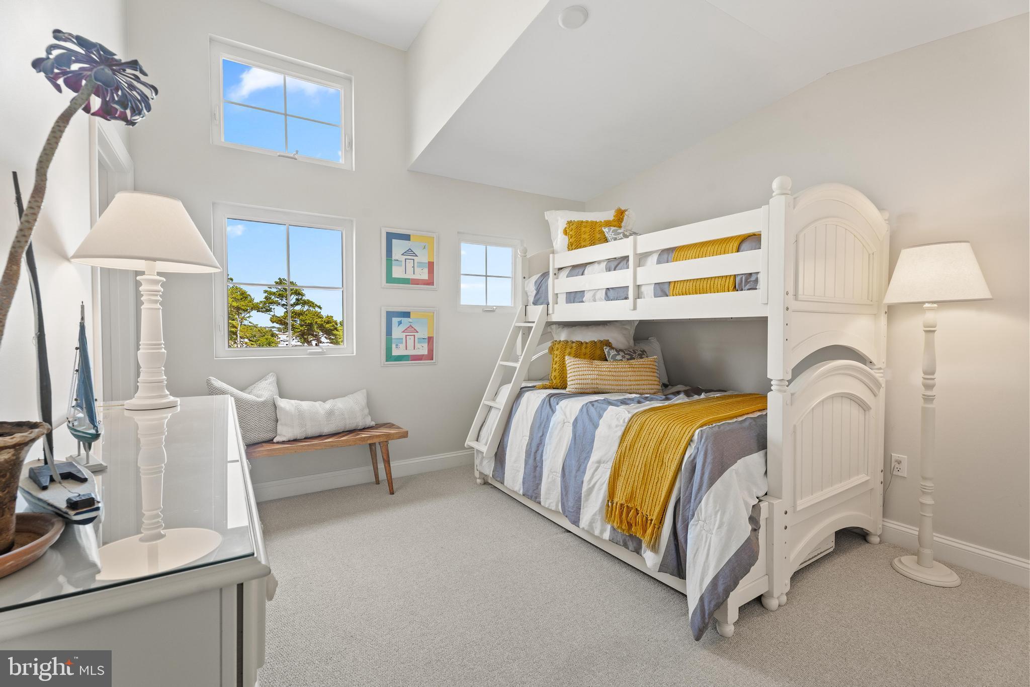 37304 Lighthouse Road, Unit 10 Selbyville, DE 19975 - Photo 28 of 40 a bedroom with a bed and lamp