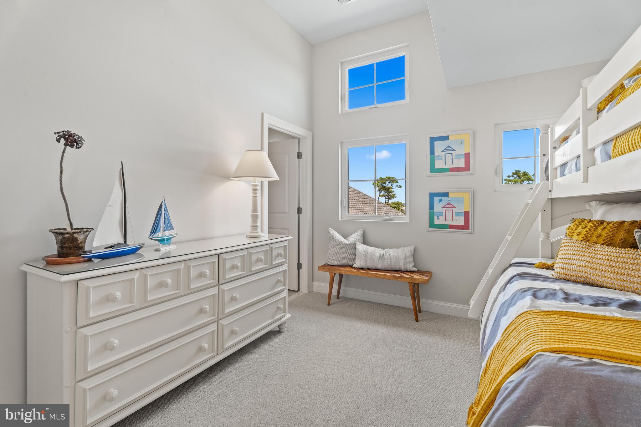 37304 Lighthouse Road, Unit 10 Selbyville, DE 19975 - Photo 29 of 40 a bedroom with a bed and a couch